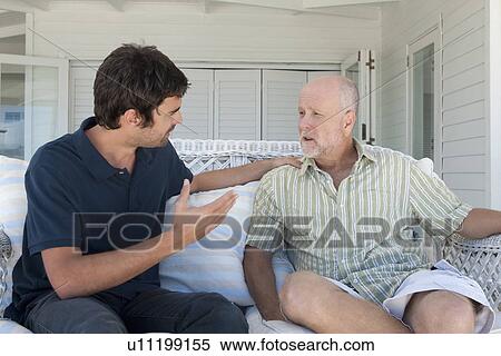 Father and son talking on sofa View Large Photo Image Stock Photography - Father and son talking on sofa. Fotosearch