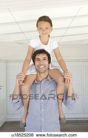 Father carrying daughter on shoulders View Large Photo Image Stock Photo - Father carrying daughter on shoulders. Fotosearch