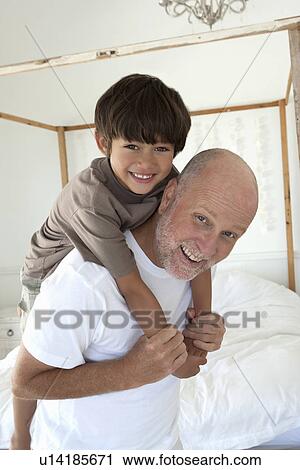 Father carrying son piggyback View Large Photo Image Stock Image - Father carrying son piggyback. Fotosearch