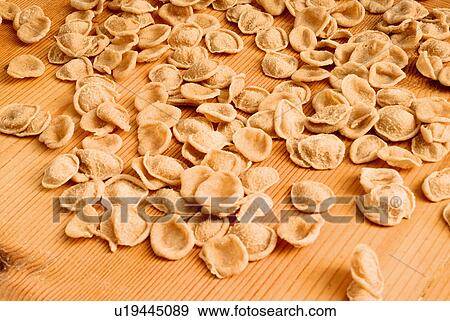 Stock Photo - Fresh pasta on wooden board. Fotosearch