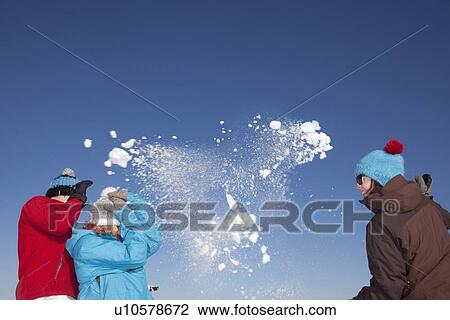 Friends having snowball fight outdoors View Large Photo Image Stock Image - Friends having snowball fight outdoors. Fotosearch