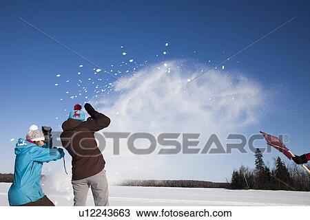 Friends playing in snow outdoors View Large Photo Image Stock Image - Friends playing in snow outdoors. Fotosearch