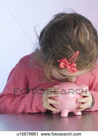 Girl kissing piggy bank View Large Photo Image Stock Image - Girl kissing piggy bank. Fotosearch