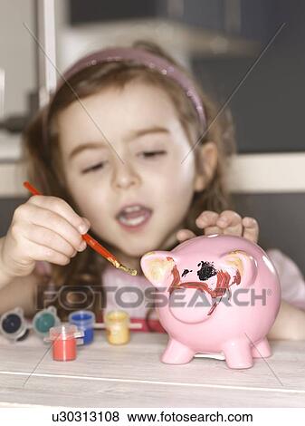 Girl painting piggy bank View Large Photo Image Stock Photo - Girl painting piggy bank. Fotosearch