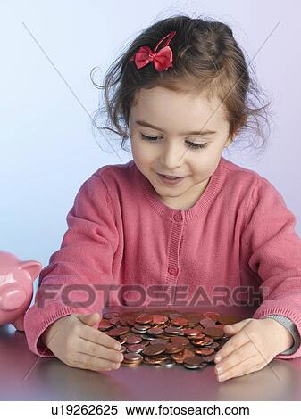 Girl playing with pile of coins View Large Photo Image Stock Photography - Girl playing with pile of coins. Fotosearch