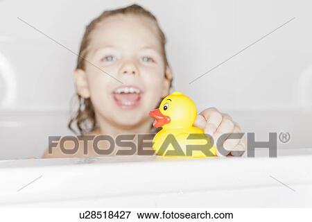 Girl playing with rubber duck in bath View Large Photo Image Stock Photo - Girl playing with rubber duck in bath. Fotosearch