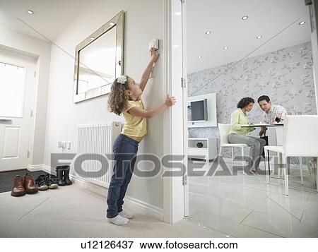 Girl reaching for thermostat View Large Photo Image Stock Photo - Girl reaching for thermostat. Fotosearch