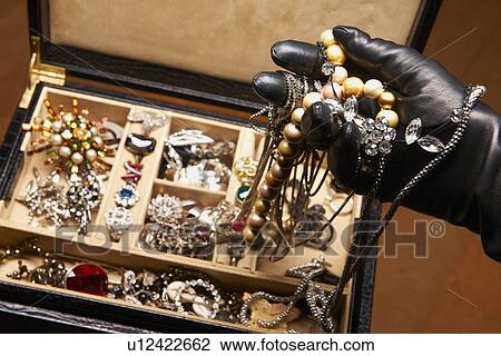 Gloved hand stealing jewelry View Large Photo Image Stock Image - Gloved hand stealing jewelry. Fotosearch