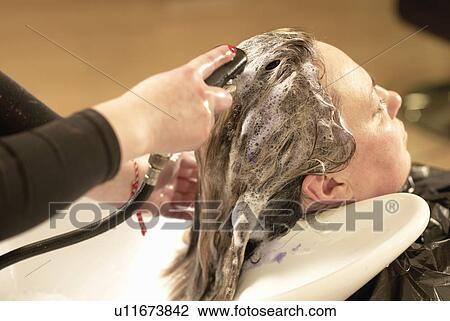 Hair stylist washing clients hair View Large Photo Image Stock Image - Hair stylist washing clients hair. Fotosearch