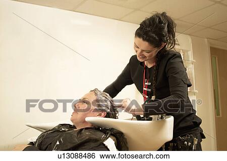 Hair stylist washing clients hair View Large Photo Image Stock Photograph - Hair stylist washing clients hair. Fotosearch