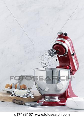 Stock Photo - Kitchen mixer with eggs and butter. Fotosearch