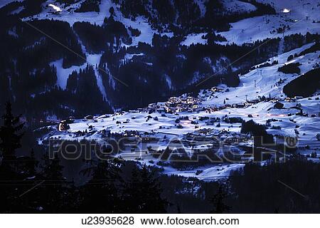 Lit village in snowy landscape at night View Large Photo Image Stock Photo - Lit village in snowy landscape at night. Fotosearch