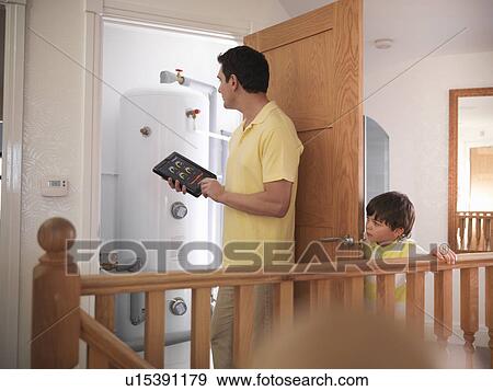 Man checking energy levels in home View Large Photo Image Stock Photo - Man checking energy levels in home. Fotosearch