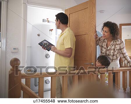Man checking energy levels in home View Large Photo Image Stock Photo - Man checking energy levels in home. Fotosearch