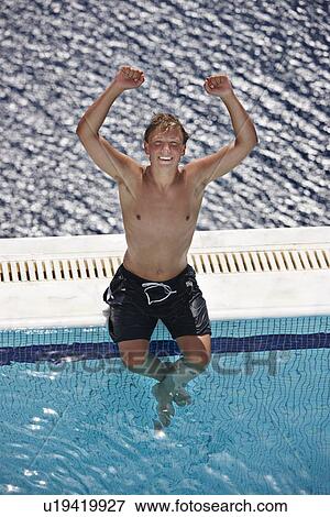 Man cheering on edge of swimming pool View Large Photo Image Stock Photo - Man cheering on edge of swimming pool. Fotosearch