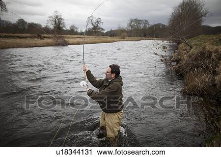 Man fishing for salmon in river View Large Photo Image Stock Image - Man fishing for salmon in river. Fotosearch