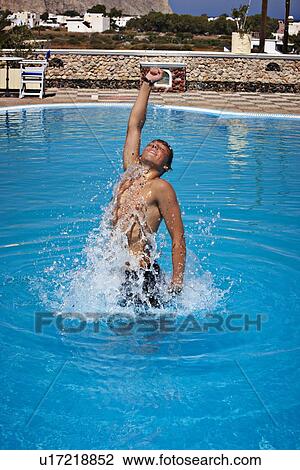 Man jumping out of swimming pool View Large Photo Image Stock Image - Man jumping out of swimming pool. Fotosearch