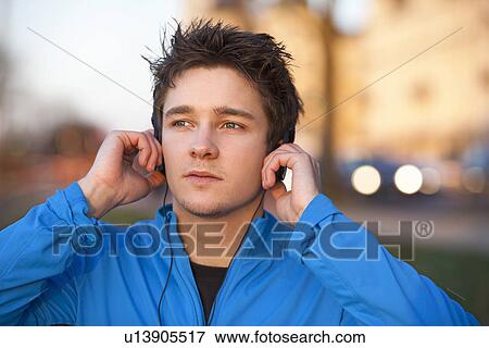 Man listening to headphones outdoors View Large Photo Image Stock Photo - Man listening to headphones outdoors . Fotosearch