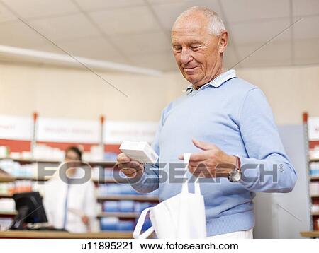 Man picking up prescription at pharmacy View Large Photo Image Stock Image - Man picking up prescription at pharmacy. Fotosearch