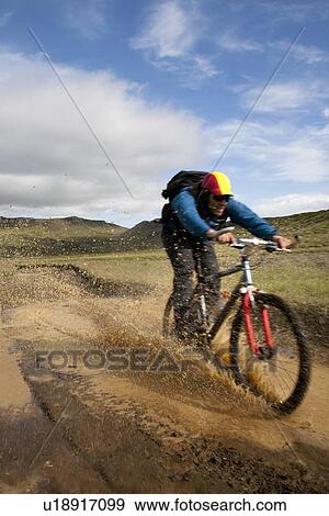 Man riding mountain bike in mud View Large Photo Image Stock Photo - Man riding mountain bike in mud. Fotosearch
