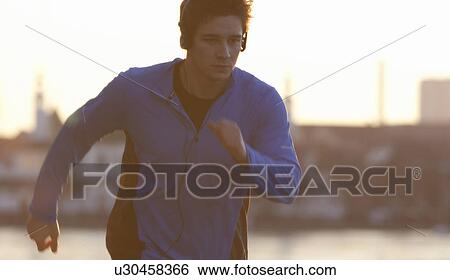 Man running in headphones View Large Photo Image Stock Photograph - Man running in headphones. Fotosearch