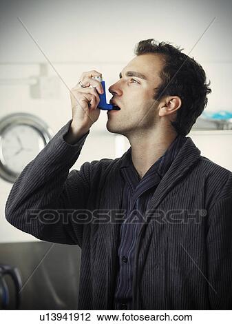 Man using asthma inhaler View Large Photo Image Stock Image - Man using asthma inhaler. Fotosearch