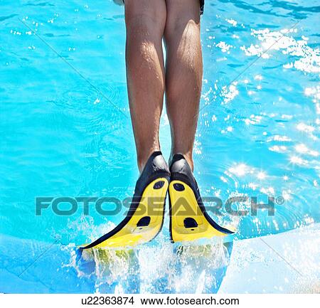 Picture - Man wearing fins in swimming pool. Fotosearch