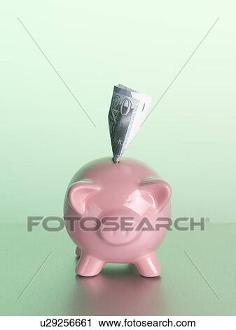 Stock Image - Money sticking out of piggy bank. Fotosearch