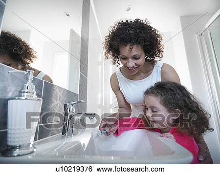 Mother and daughter brushing teeth View Large Photo Image Stock Photograph - Mother and daughter brushing teeth. Fotosearch
