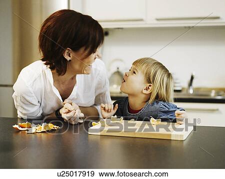 Mother and daughter peeling orange View Large Photo Image Stock Photo - Mother and daughter peeling orange. Fotosearch