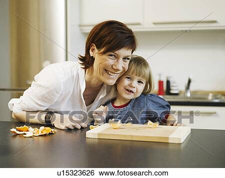 Mother and daughter peeling orange View Large Photo Image Stock Photograph - Mother and daughter peeling orange. Fotosearch