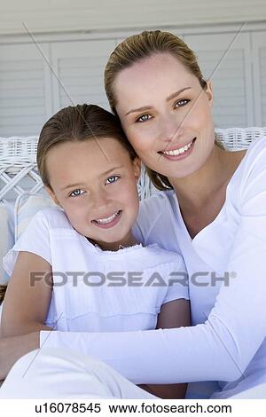 Mother and daughter relaxing on sofa View Large Photo Image Stock Photography - Mother and daughter relaxing on sofa. Fotosearch