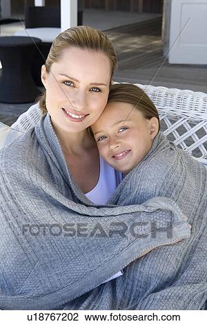 Mother and daughter wrapped in blanket View Large Photo Image Stock Image - Mother and daughter wrapped in blanket. Fotosearch
