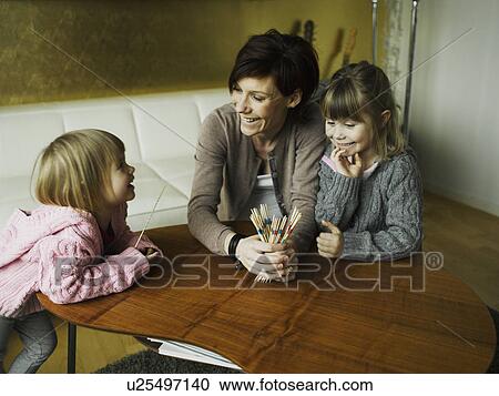Mother and daughters playing together View Large Photo Image Stock Image - Mother and daughters playing together. Fotosearch