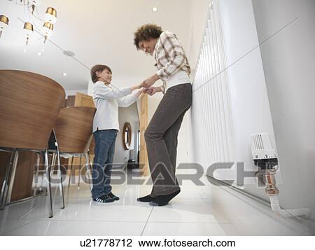Mother and son holding hands in kitchen View Large Photo Image Stock Image - Mother and son holding hands in kitchen. Fotosearch