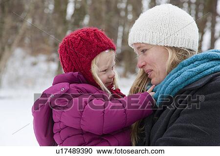 Mother carrying daughter in snow View Large Photo Image Stock Image - Mother carrying daughter in snow. Fotosearch