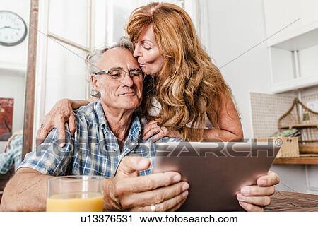 Stock Image - Older couple using tablet computer. Fotosearch