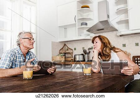 Older couple using tablet computers View Large Photo Image Stock Photograph - Older couple using tablet computers. Fotosearch