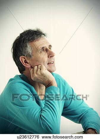 Stock Photograph - Older man resting chin in hand. Fotosearch