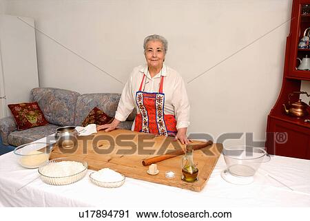 Older woman baking in living room View Large Photo Image Stock Image - Older woman baking in living room. Fotosearch
