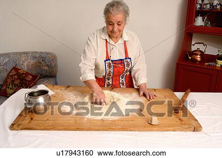 Older woman baking in living room View Large Photo Image Stock Image - Older woman baking in living room. Fotosearch