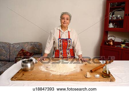 Older woman baking in living room View Large Photo Image Stock Image - Older woman baking in living room. Fotosearch