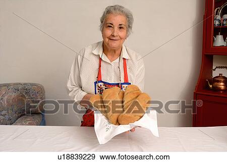 Older woman making bread in living room View Large Photo Image Stock Photo - Older woman making bread in living room. Fotosearch