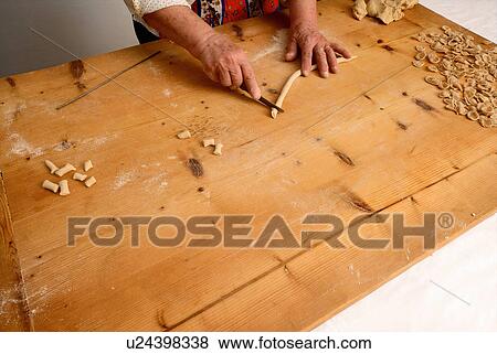Older woman making pasta from dough View Large Photo Image Stock Photo - Older woman making pasta from dough. Fotosearch