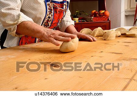 Older woman rolling dough on board View Large Photo Image Stock Photograph - Older woman rolling dough on board. Fotosearch