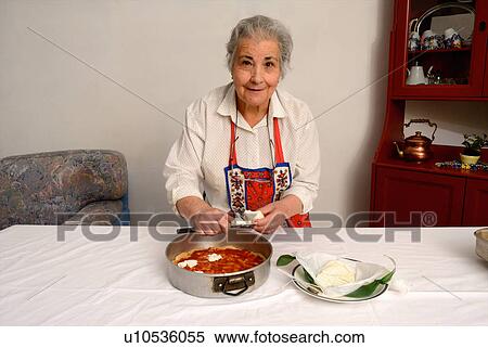 Older woman slicing cheese for pizza View Large Photo Image Stock Photography - Older woman slicing cheese for pizza. Fotosearch