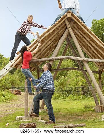 People building log hut together View Large Photo Image Stock Photo - People building log hut together. Fotosearch