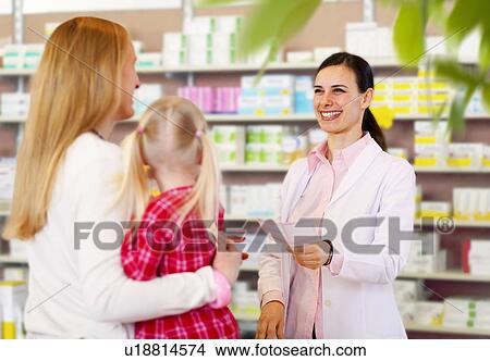 Pharmacist giving prescription to mother View Large Photo Image Picture - Pharmacist giving prescription to mother. Fotosearch