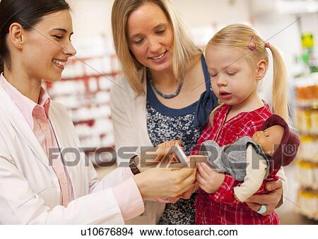 Pharmacist putting bandage on doll View Large Photo Image Picture - Pharmacist putting bandage on doll. Fotosearch
