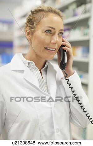 Pharmacist talking on phone View Large Photo Image Stock Photography - Pharmacist talking on phone. Fotosearch
